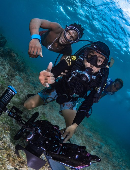 Witu Islands, Papua New Guinea, Film crew making scuba video with locals on coral reef