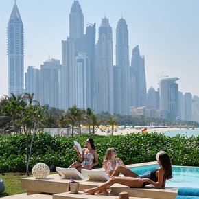 Overview of the Dubai skyline with charter guests relaxing in the foreground