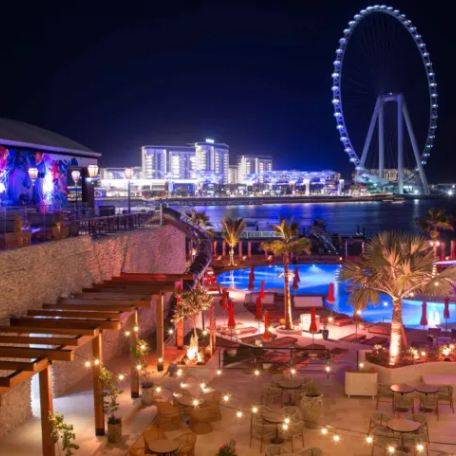 Overview of the Dubai skyline at night with many lights