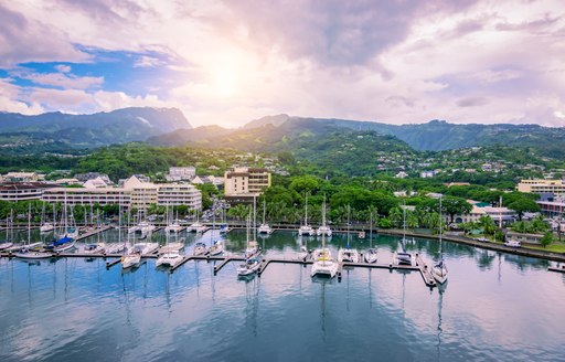 superyachts docked in a port in Tahiti