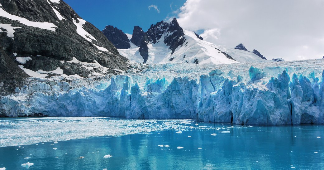 Turquoise glaciers, rocky mountains and calm waters on South Georgia Island