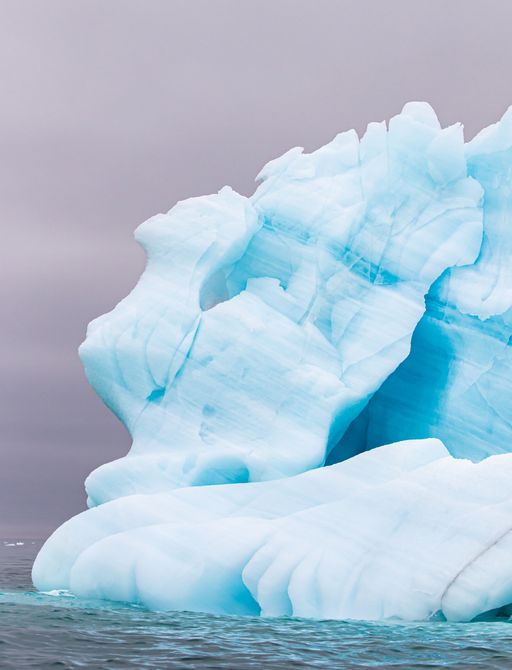 A blue-tinged iceberg in Svalbard, Arctic North