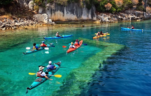 Kayakers paddle over Kekova sunken city in Turkey