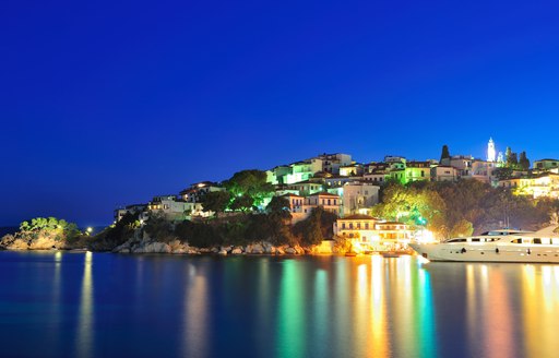 Yacht parked outside Skiathos town and harbor in Greece at night