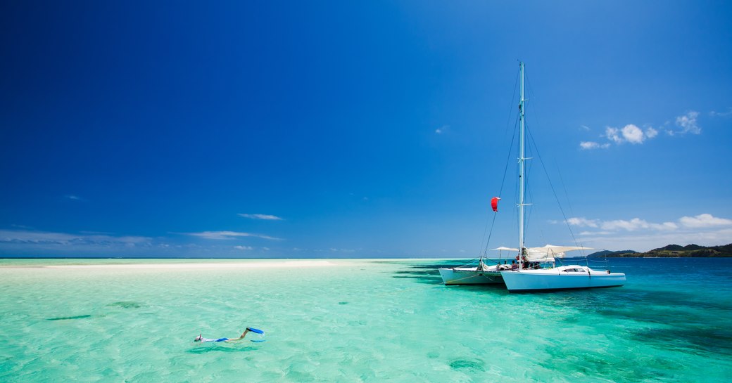 Snorkeling in shallow tropical water off the catamaran