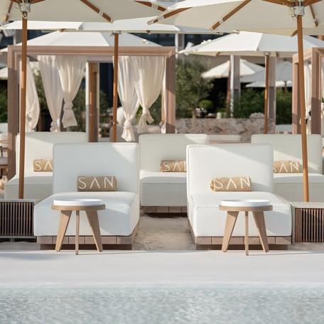 White seating arranged at the SAN Beach beach club in Dubai