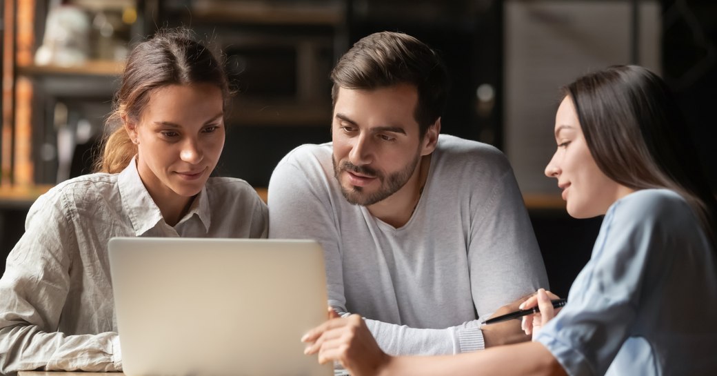 a couple chatting with an agent booking a vacation