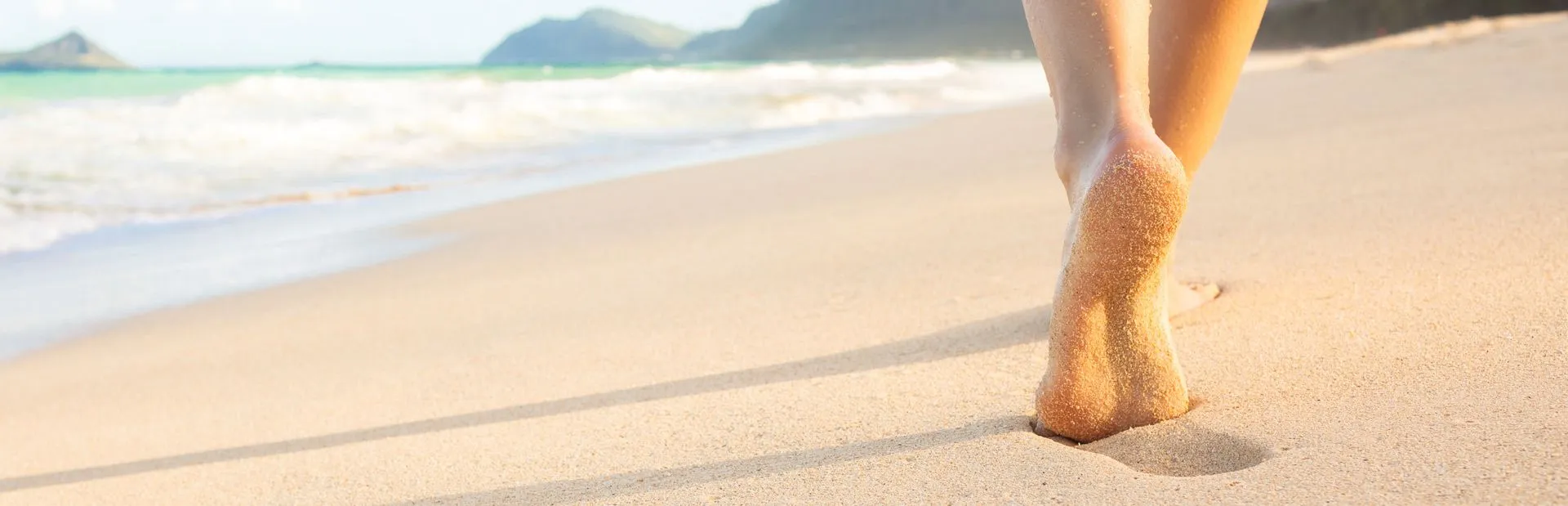 Feat walking on a sandy beach 